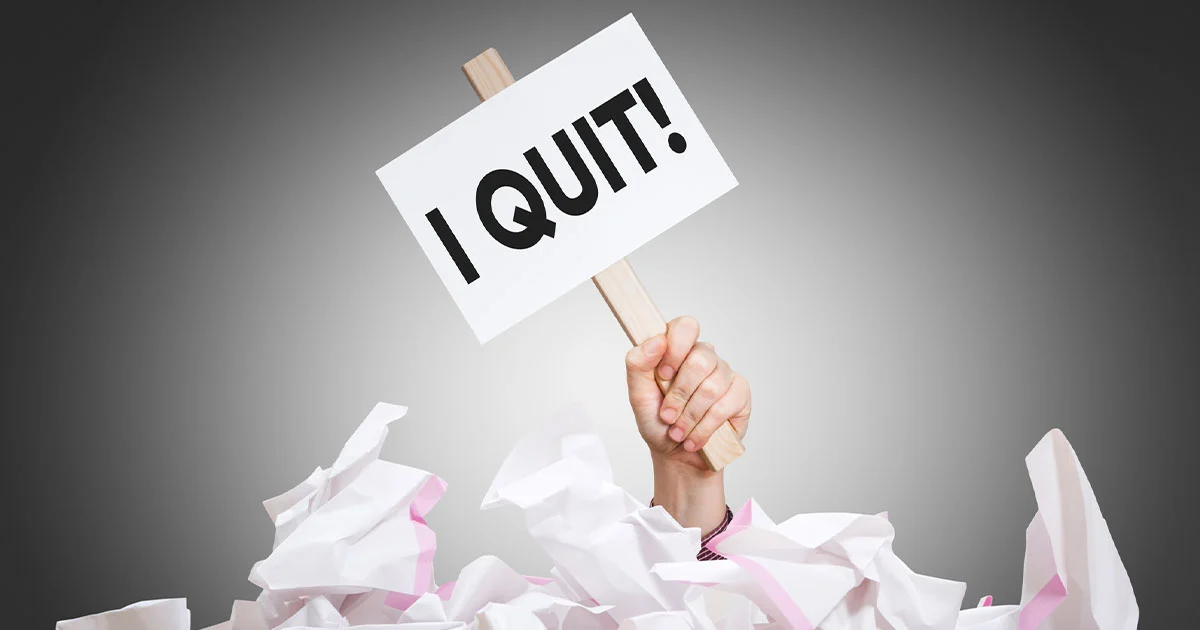 hand holding I quit sign